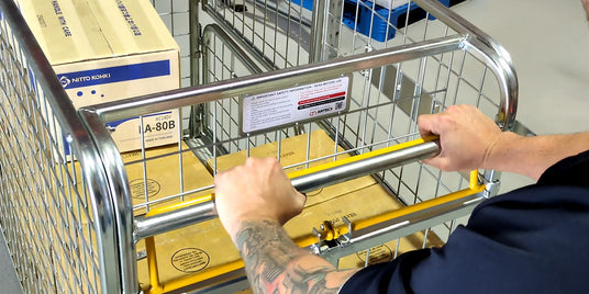 person pushing cart in a warehouse