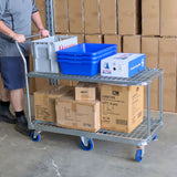 worker pushing 62 tier trolley in warehouse loaded with totes and cartons