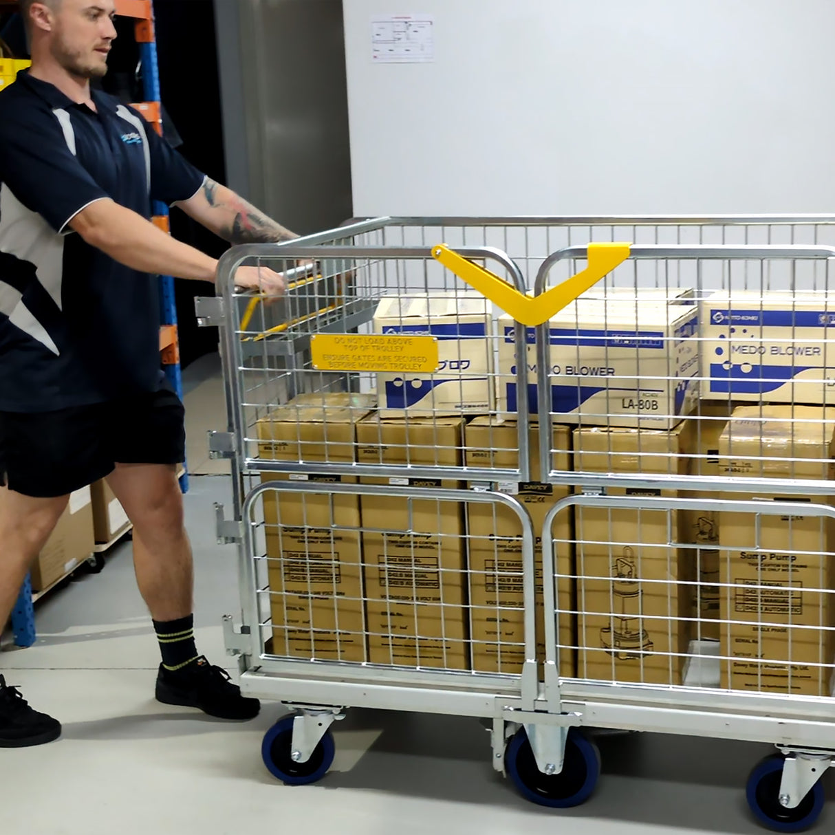 Person pushing a cart with boxes in a warehouse setting